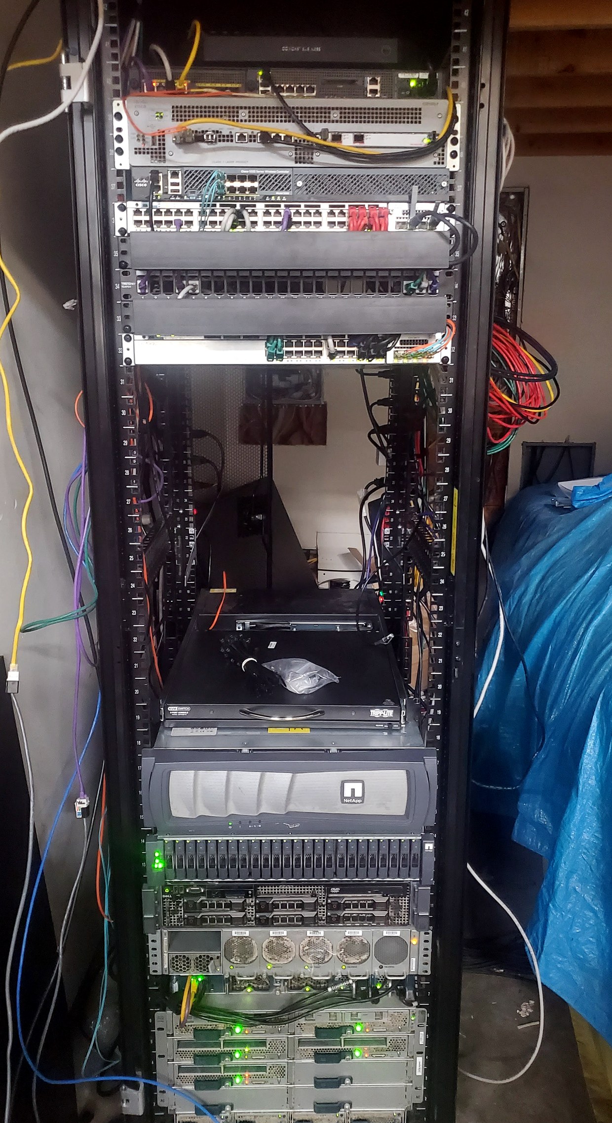 Home lab rack with NetApp storage, Dell servers, switching, patch panels, and KVM console